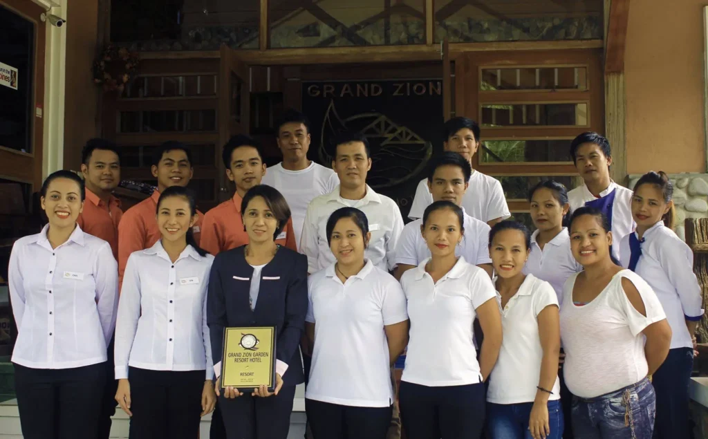 staff of Grand Zion holding accreditation plaque